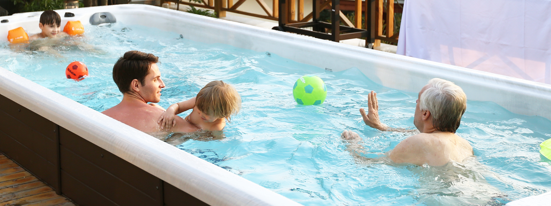 dad, grandad and kid playing in an oasis spa